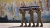 Ukraine -- Soldiers carry the coffin of their comrade, a Ukrainian military officer killed during fighting against Russians, during his funeral at St Michael cathedral in Kyiv, Ukraine, Thursday, Sept. 8, 2022. 