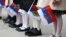 Russia -- Pupils hold the Russian flags during a Knowledge Day ceremony