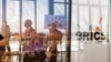 BRICS-SUMMIT/ Delegates walk past the logos of the BRICS summit during the 2023 BRICS Summit at the Sandton Convention Centre in Johannesburg, South Africa on August 23, 2023. GIANLUIGI GUERCIA/Pool via REUTERS