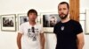FRANCE – Ukrainian photographers Evgeniy Maloletka (L) and Mstyslav Chernov (R) pose in front of their photos at "Marioupol, Ukraine" exhibition during the edition of the Visa pour l'Image international photojournalism festival in Perpignan, 31Aug2022