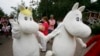 Moomin characters meet visitors at Moomin World theme park in Naatali