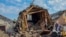 UKRAINE -- Locals clear debris and fix damaged piping in the aftermath of a rocket attack in the Zolochiv settlement of the Kharkiv's area, Ukraine, 14 May 2023,