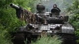 UKRAINE -- Ukrainian servicemen check their T-72 tank at a position in the Donetsk region on June 25, 2023