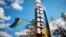 UKRAINE – A Ukrainian national flag flies on an entrance to the town of Kupiansk, liberated by the Ukrainian Armed Forces, amid Russia's attack on Ukraine, in Kharkiv region, September 19, 2022