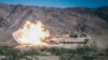 An M1A1 Abrams tank fires its 120mm cannon 