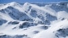 Bulgaria -- Volunteers help five people with various disabilities to reach the snow-covered peaks of the Rila Mountain.