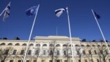 NATO and Finland flags flutter over the building of Ministry of Internal Affairs in Helsinki, Finland, Tuesday, April 4, 2023. (AP Photo/Sergei Grits)