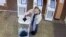 Russia - Moscow - a woman dumps green antiseptic dye (zelyonka) into a ballot box during Russian elections - screen grab