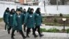 Russia -- A procession of inmates passes by at female penal colony