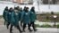 Russia -- A procession of inmates passes by at female penal colony