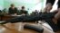 ITAR-TASS 20: IVANOVO, RUSSIA. MARCH 15, 2010. Secondary school students watch their instructor disassemble a replica gun during a general military training class in the city of Ivanovo