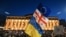 A protesters wave the Georgian, Ukrainian and European flags during a demonstration in Tbilisi on March 8, 2023.