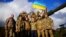 U.K. – British Defence Secretary Ben Wallace C) poses with Ukrainian personnel training at Bovington Camp, near Wool in southwestern Britain, February 22, 2023