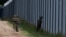 Polish soldiers patrol along the border fence on the Polish-Belarusian border in Usnarz Gorny, Poland, August 30, 2023. REUTERS