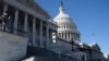 A person stands outside the U.S. Capitol, before a vote to begin work on a bill that includes aid for Ukraine, Israel and Taiwan in Washington in U.S. Senate, U.S., February 9, 2024. REUTERS/Nathan Howard
