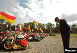 Мужчина на могиле своего сына, погибшего в Украине, Владикавказ, 22 августа 2022 года