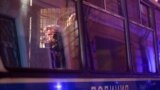 RUSSIA -- A man sits in a police vehicle during a demonstration after Russian opposition leader Alexei Navalny was sentenced to three and a half years in jail, in Moscow, Russia February 2, 2021