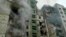 Fumes from dilapidated buildings are seen after the shelling attack by the Russian army, in Chernihiv. 