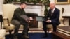 USA – Ukraine's President Volodymyr Zelenskiy delivers a soldier's gift to U.S. President Joe Biden in the Oval Office at the White House in Washington, U.S., December 21, 2022