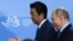 RUSSIA -- Japanese Prime Minister Shinzo Abe and Russian President Vladimir Putin arrive for a signing ceremony following their meeting in Vladivostok, September 10, 2018