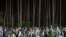 UKRAINE RUSSIA CONFLICT -- People mourn at the graves of a cemetery in Irpin, Ukraine, May 1, 2022.