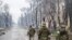 Russian servicemen patrol the captured Levoberezhny District of Mariupol, Ukraine on April 13, 2022.
