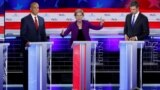 Miami, Florida, U.S. - U.S. Senator Elizabeth Warren speaks as U.S. Senator Cory Booker and former U.S. Rep. Beto O'Rourke listen at the first U.S. 2020 presidential election Democratic candidates debate in Miami, Florida, U.S., June 26, 2019. REUTERS/Mik