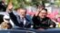 North Korea -- North Korean leader Kim Jong Un (R) and South Korean President Moon Jae-in (L) wave to Pyongyang citizens from an open-topped vehicle as they drive through Pyongyang on September 18, 2018. South Korea's president and the North's leader Kim 