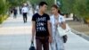 Turkmenistan couple holding hands in public
