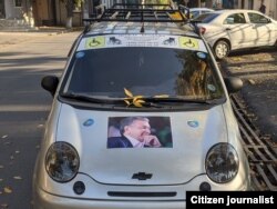 An image of President Mirziyoyev is seen on a supporter's car in Tashken on election day, October 24, 2021.