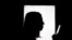 Silhouette of a woman using smart phone mobile.