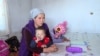 Kyrgyzstan - mother Zhazgul Raimbek kyzy, whose family of eight lives in a rickety house just meters from a landfill in the Kyrgyz capital, Bishkek. screen grab