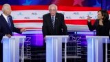 Miami, Florida, U.S - Former Vice President Joe Biden and Senator Kamala Harris / Former Vice President Joe Biden and Senator Kamala Harris debate racial issues as Senator Bernie Sanders listens during the second night of the first U.S. Democratic preside