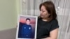 Гаухар Керимбекова держит портрет своего сына Султана. Его убили выстрелом в голову 5 января 2022 года. Стрелявший не найден, дело закрыто. Алматы, 5 января 2023 года