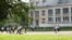 Russia - Scene from Russian school yard with view to groups of playing kids past a green lawn, Pushkin, Russia. 12Sep2017