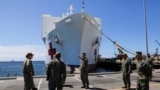 Members of the army are seen, as the USNS Mercy, a Navy hospital ship, departs the Naval Station San Diego and heads to the Port of Los Angeles to aid local medical facilities dealing with coronavirus disease (COVID-19) patients, in San Diego, California,