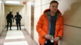 RUSSIA -- Russian opposition leader Aleksei Navalny stands near law enforcement agents in a hallway of a business centre, which houses the office of his Anti-Corruption Foundation (FBK), in Moscow, December 26, 2019