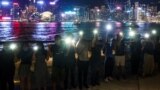 Hong Kong, China - Protesters hold hands to form a human chain during a rally to call for political reforms at the Avenue of Stars 