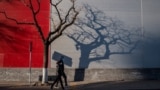CHINA -- A man and a woman wearing face masks as a preventive measure against the COVID-19 coronavirus walk on a street in Beijing, March 4, 2020