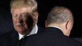 JAPAN -- U.S. President Donald Trump walks past Turkey's president Recep Tayyip Erdogan as they pose for a group photo during the G20 Summit in Osaka, June 27, 2019