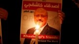 TURKEY -- A demonstrator holds a poster with a picture of Saudi journalist Jamal Khashoggi outside the Saudi Arabia consulate in Istanbul, Turkey October 25, 2018.