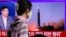 NORTH KOREA-A woman watches a TV broadcasting a news report on North Korea's launch of three missiles including one thought to be an intercontinental ballistic missile (ICBM), in Seoul, South Korea, May 25, 2022.