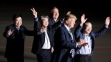U.S. -- The three Americans formerly held hostage in North Korea gesture next to U.S.President Donald Trump and Secretary of State Mike Pompeo, upon their arrival at Joint Base Andrews, Maryland, May 10, 2018