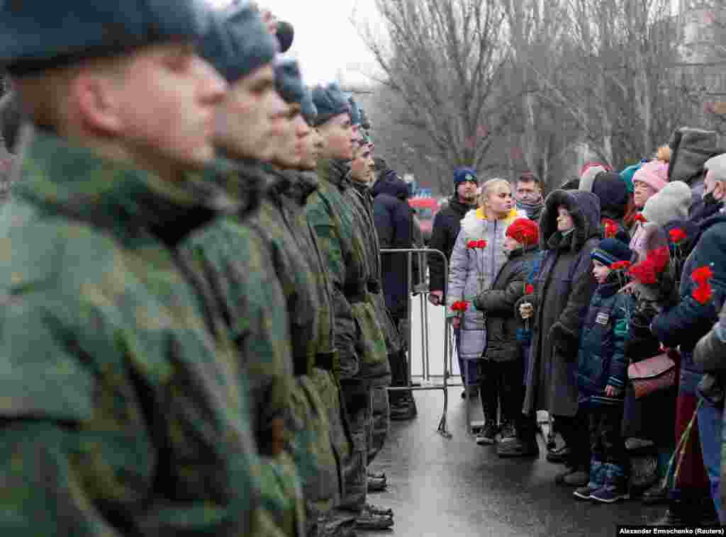 Local residents and cadets of the region controlled by a Russia-backed separatist group that calls itself the Donetsk People&#39;s Republic during a January 22 ceremony marking the fatal shelling of a trolleybus seven years earlier in Donetsk.
