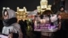 RUSSIA -- Demonstrators holding a placard with images of three Khachaturyan sisters, accused of murdering their father, protest against violence towards women in Moscow, November 25, 2019