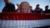 Avoca, Pennsylvania - A man holds a placard depicting U.S. President Donald Trump at a campaign rally at Wilkes-Barre Scranton International Airport in Avoca, Pennsylvania, U.S
