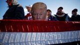 Avoca, Pennsylvania - A man holds a placard depicting U.S. President Donald Trump at a campaign rally at Wilkes-Barre Scranton International Airport in Avoca, Pennsylvania, U.S