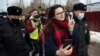 RUSSIA -- Activist Ksenia Pakhomova, foreground, takes a selfie as police officers detain her at the prison colony IK-2, which stands out among Russian penitentiary facilities for its particularly strict regime, in Pokrov in the Vladimir region, 85 kilome