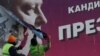 Slaviansk, Ukraine - Municipal workers remove an election poster of Ukrainian President and presidential candidate Petro Poroshenko in Slaviansk, Ukraine March 28, 2019. REUTERS/Gleb Garanich