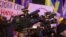 UKRAINE – Group of cameramen, journalists and reporters with professional video cameras at street political action. Crowd of people is around. Kyiv, December 1, 2021 